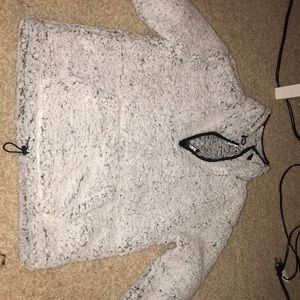 Fuzzy pull over jacket with small zipper at top